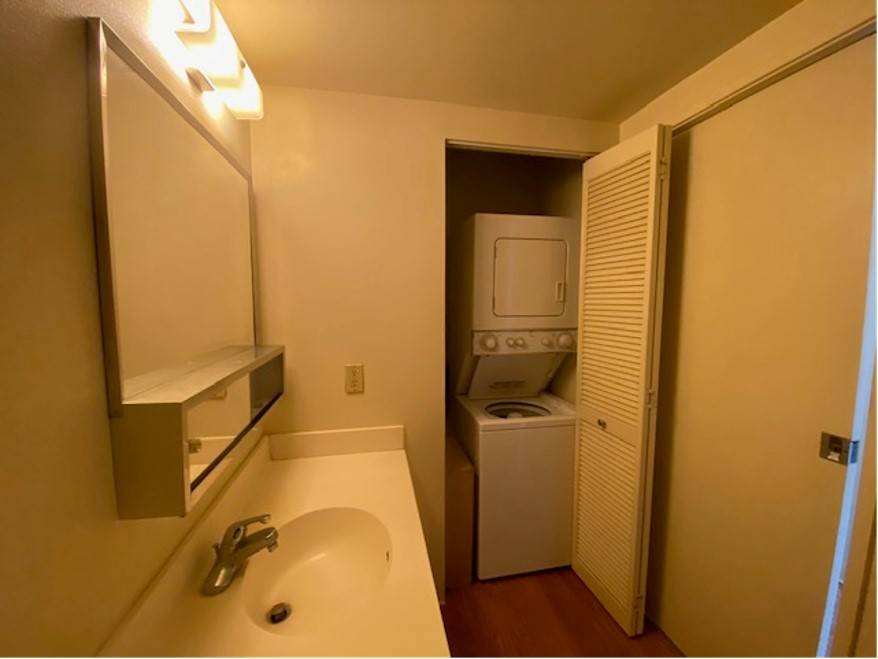 A small bathroom with a washer and dryer in it.